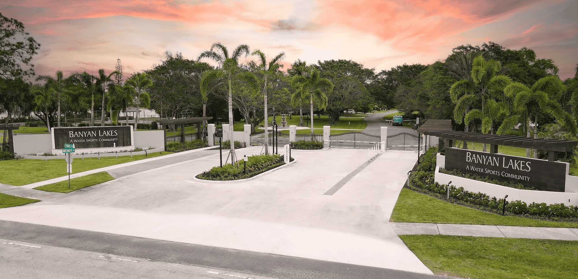 Modern community entrance with white walls and contemporary signage