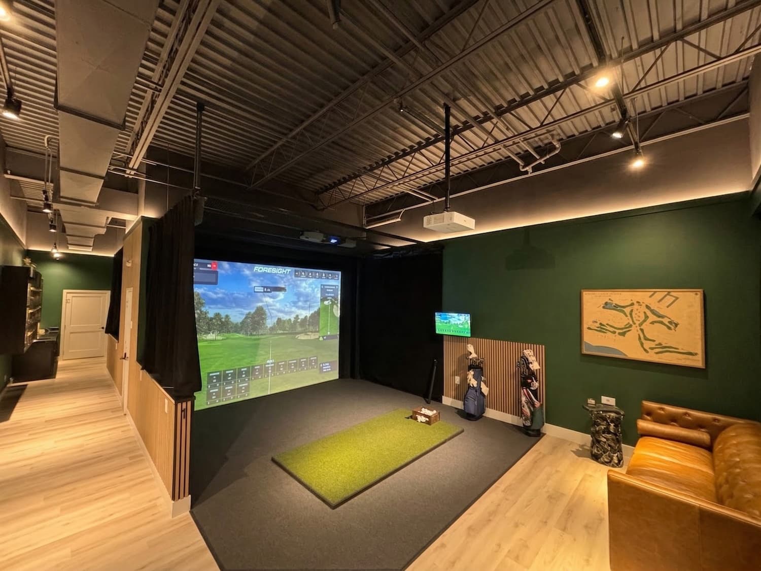 Upscale indoor golf club with simulator and lounge seating